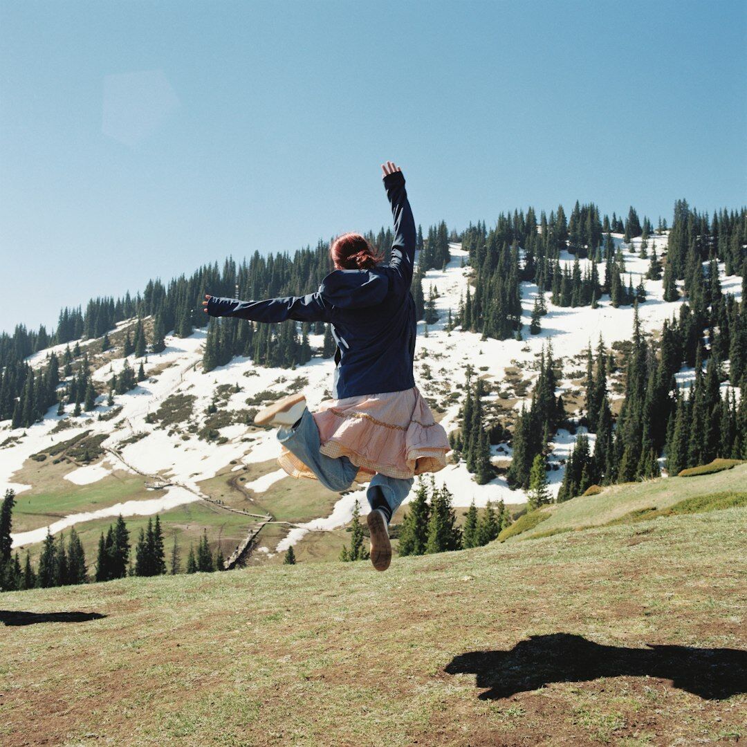 Diverse group of young colleagues jumping and celebrating together outdoors