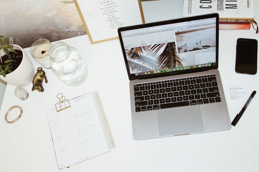 Flat lay of magazines, a laptop and a coffee cup on a desk