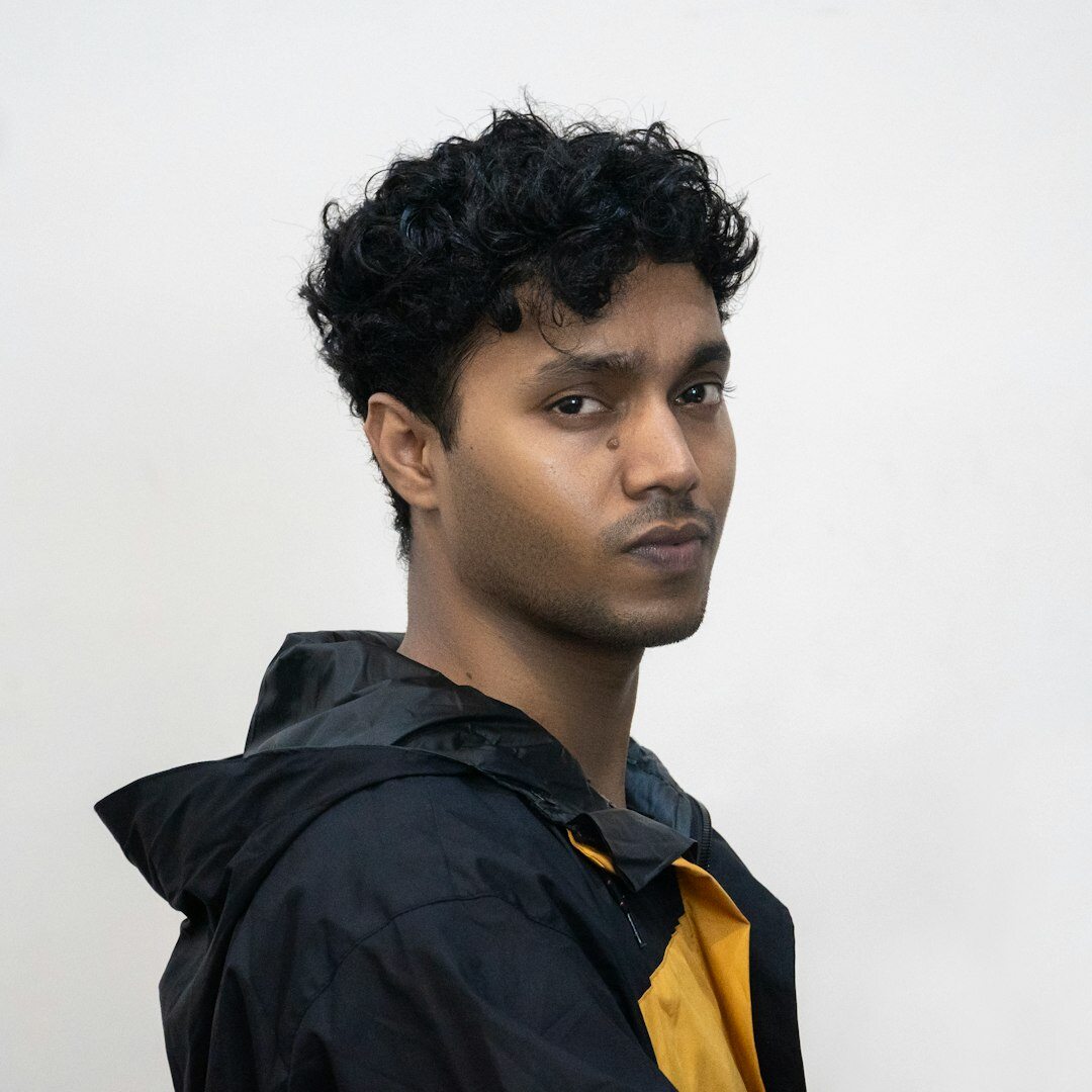 Studio portrait of a young man with short curly hair