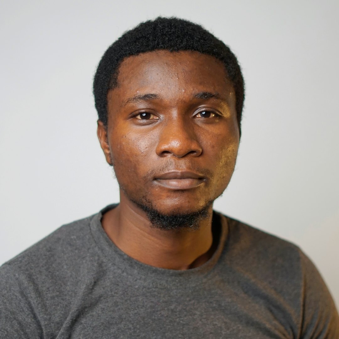 Studio portrait of a smiling man with short dark hair